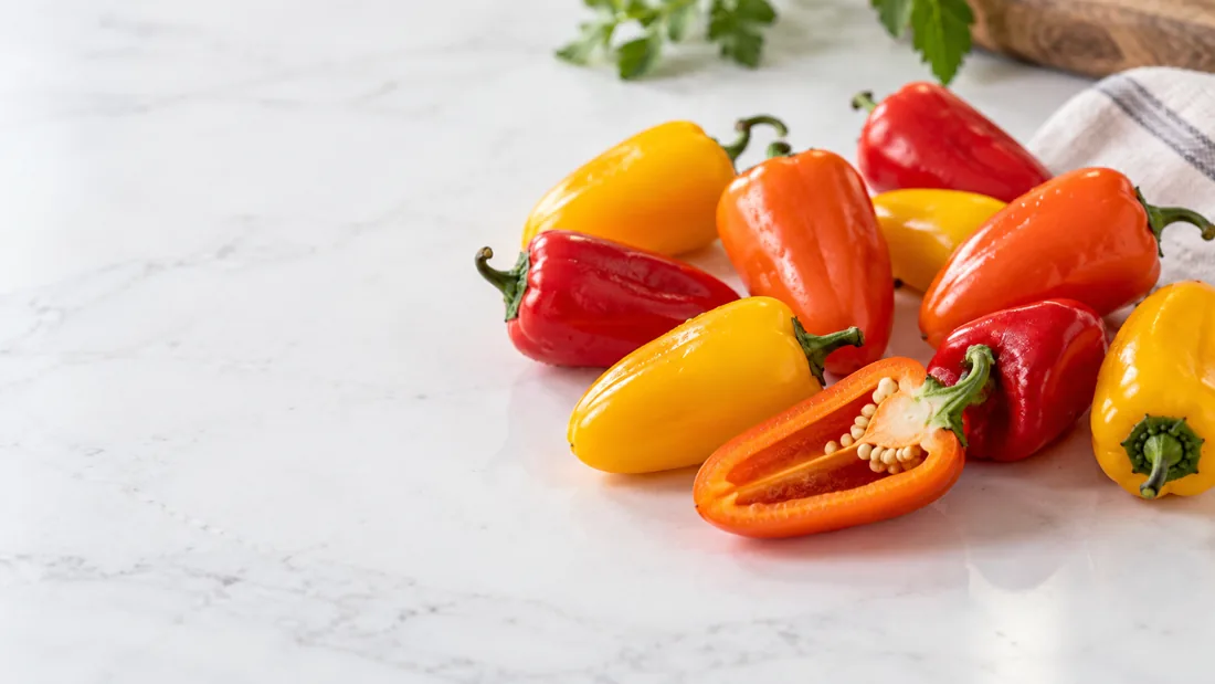 Fresh finger-sized mini sweet peppers, whole and halved